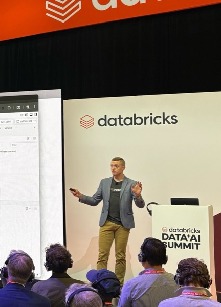 James speaking to an audience at a conference